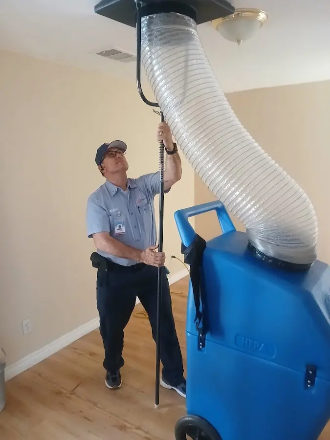 Furnace Tune-Up technician using HEPA equipment in Kirkwood